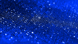 A 3D-rendered image of a glowing blue circuit board, symbolizing futuristic AI processor power and data flow. The intricate maze of circuits appears illuminated, creating a visual effect of energy and movement across the board, representing advanced computing and AI technology.